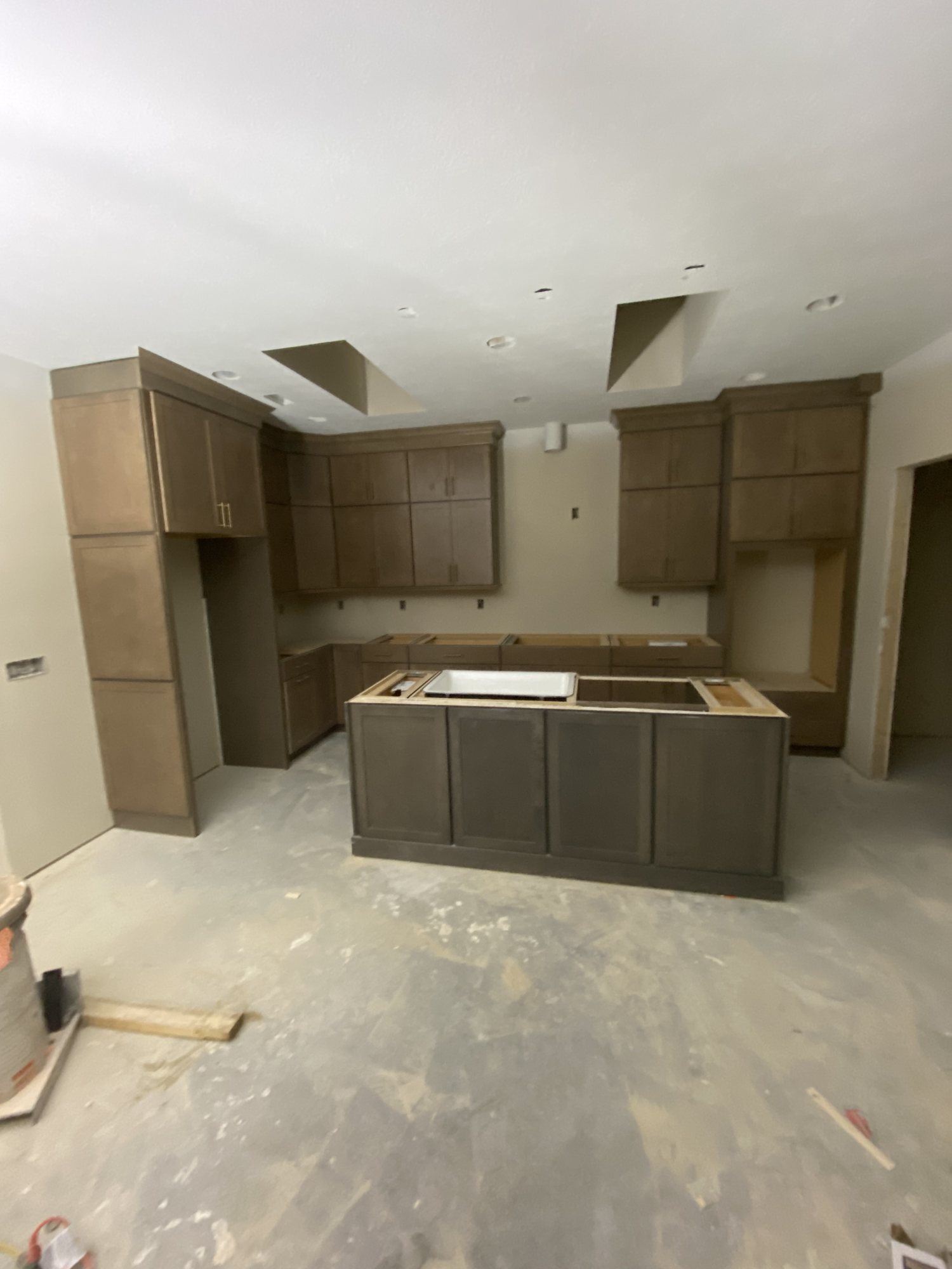 Cabinet run and island set and levelled, waiting on countertops