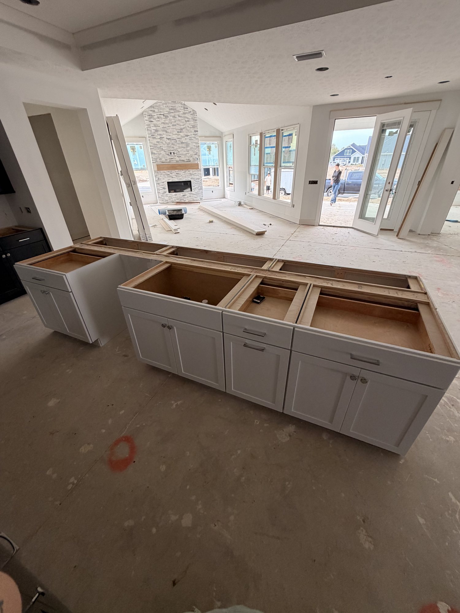 White base cabinetry set across an open-plan kitchen