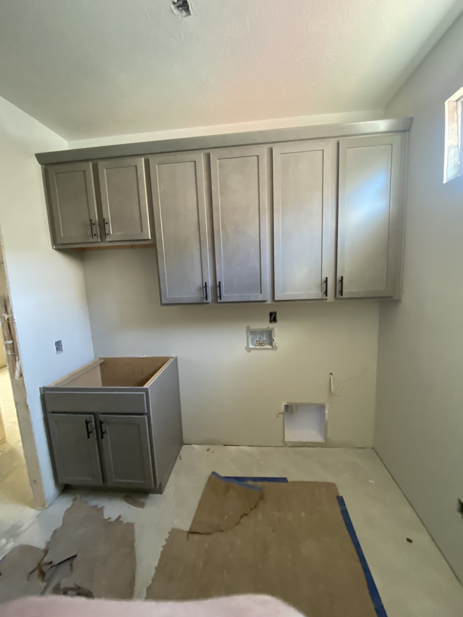 Grey cabinetry set in a utility kitchen
