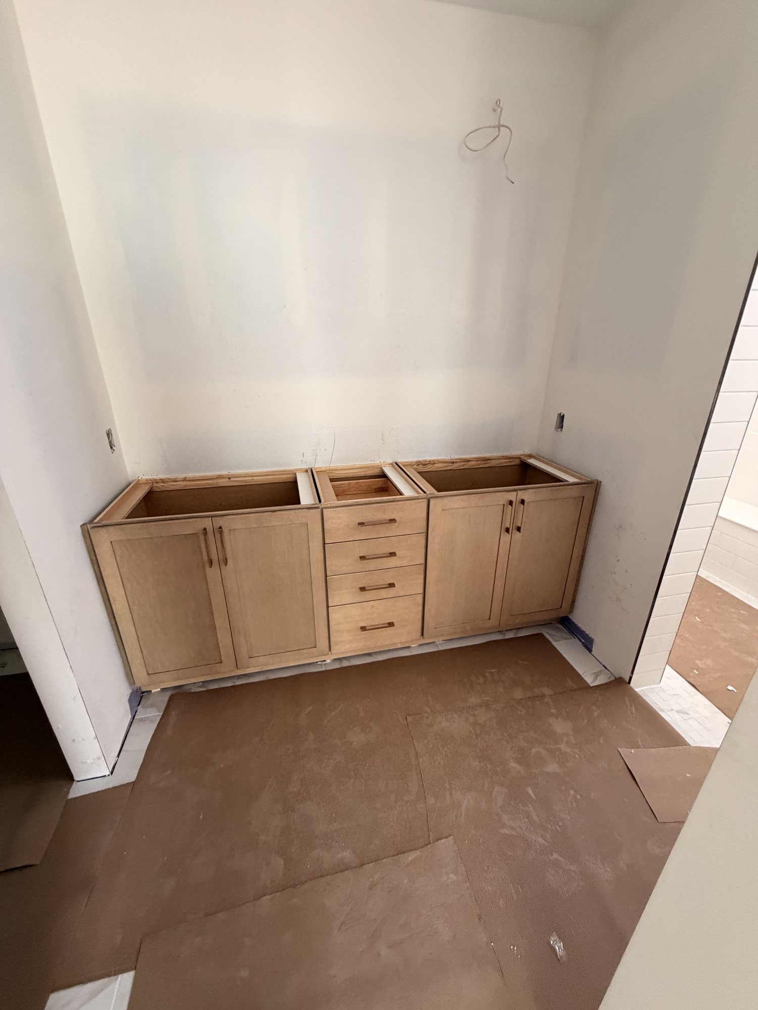 Natural oak cabinet run set and levelled before tops